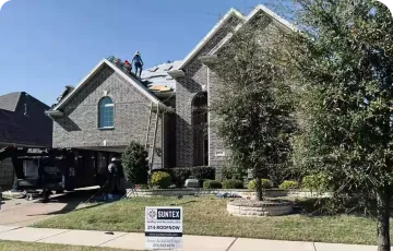 Roofing work on a steep residential roof