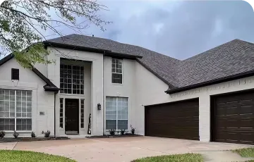 House with a white painted exterior and dark shingle roof