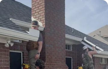 Gutter work along a brick home roofline
