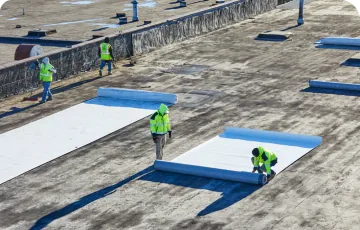 Workers installing a commercial flat roof system